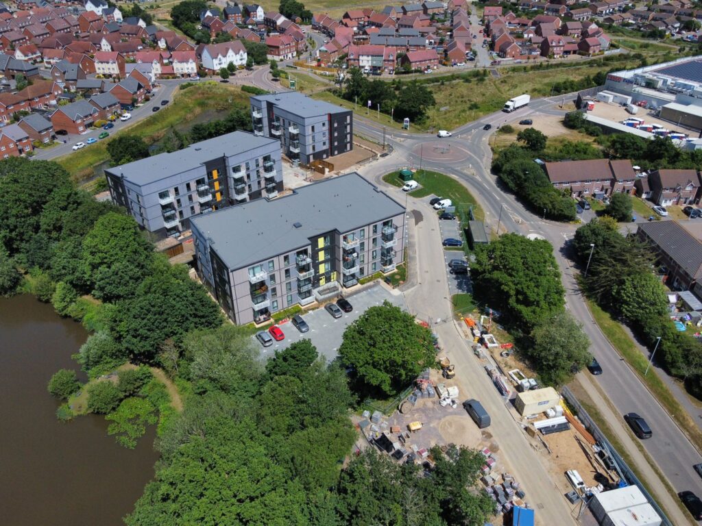 an aerial photograph showing 3 completed apartment blocks