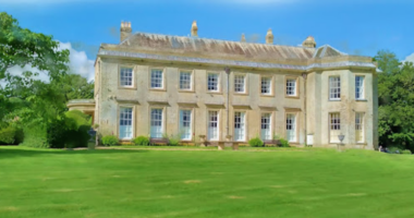 Conholt Park - a photo of a large stately home showing the grassy lawn and trees