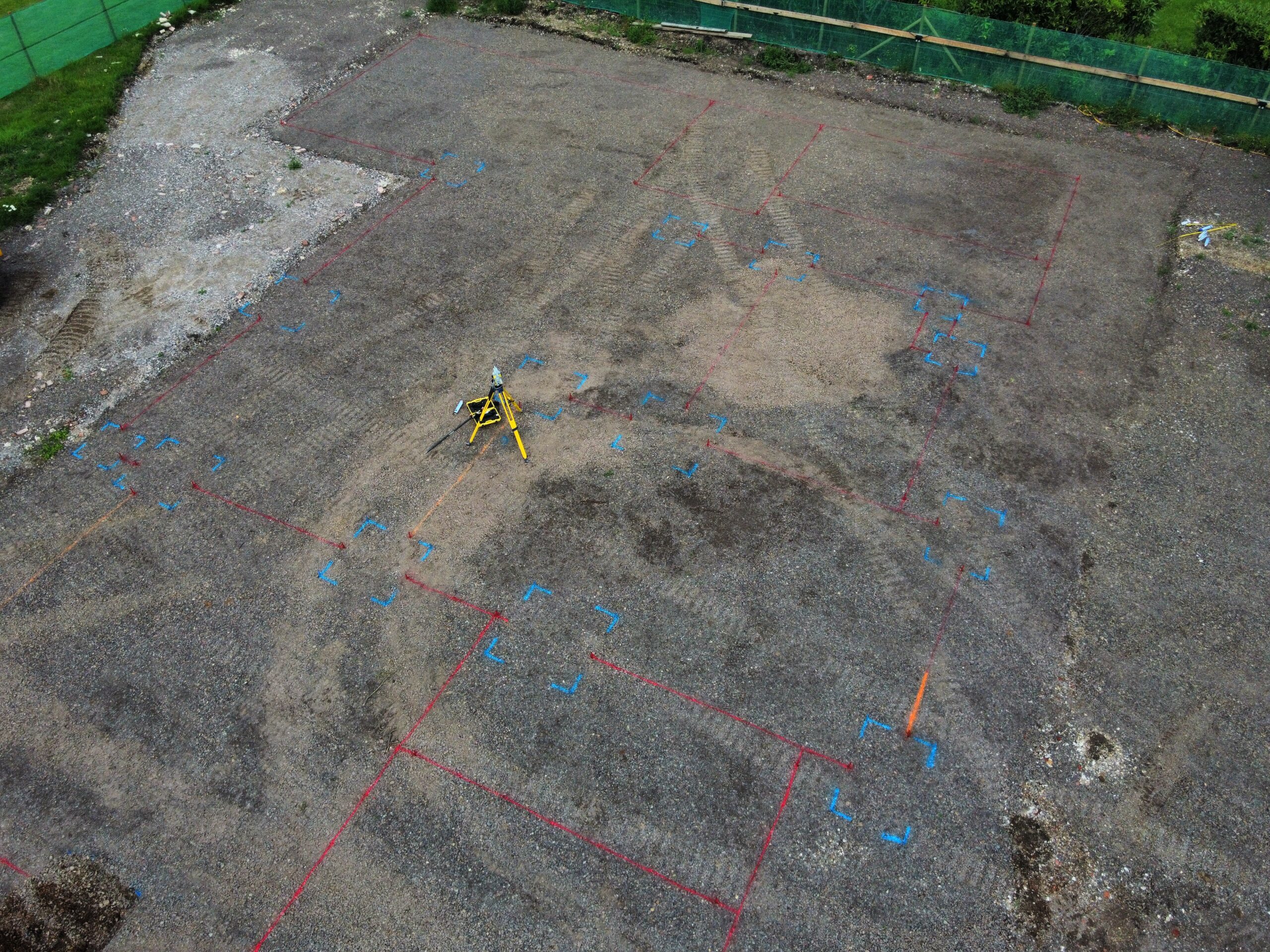 Aeiral photograph showing foundation's for a building marked ready for excavation, with a Surveying Total Station visible