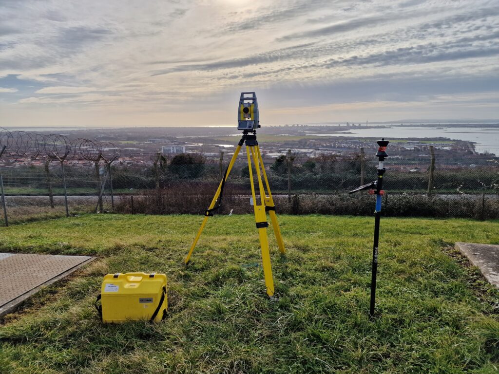 Image of total station surveying equipment over Portsmouth with box for station and Prism visible