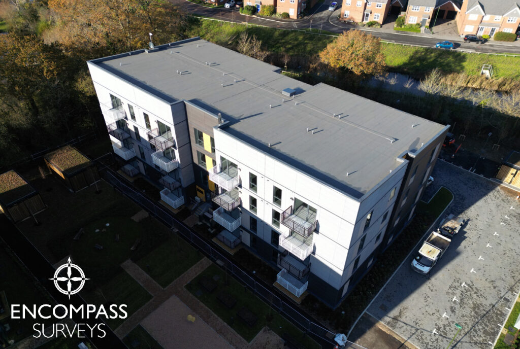 An aerial drone photo of a roof inspection on a block of new build modular apartments